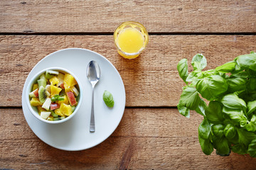 organic healthy whole breakfast fruitsalad and orange juice