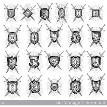 Set of different geometric shields with light ray and crossed swords behinde