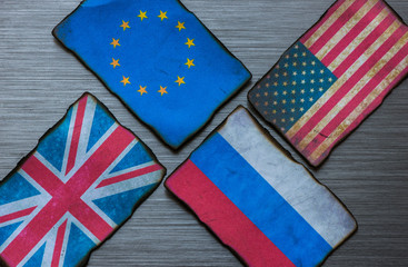 European, American, Russian and British flags on brushed metal texture background