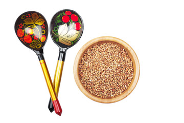 Buckwheat groats in wooden dish and Russian traditional wooden s