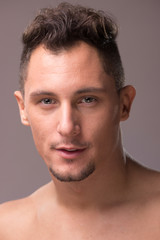 Fototapeta premium young adult man looking at camera head face closeup