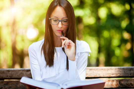 Young woman studying at the park