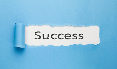 success text written on paper on blue background