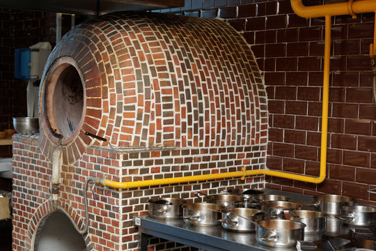 Vertical gas heated tandoor oven in restaurant kitchen