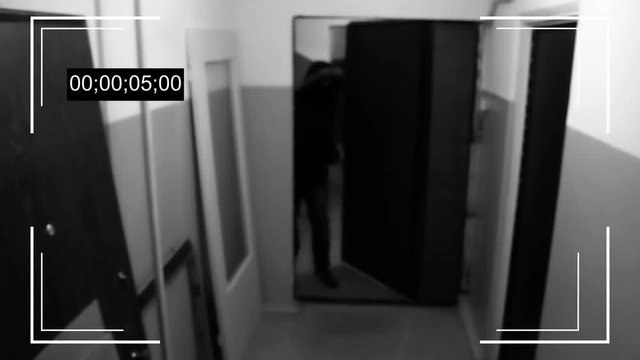 the young man in the mask breaks the door and breaks the surveillance camera
