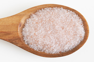 Fototapeta na wymiar Pink himalayan salt in wooden spoon isolated on white background. Top view