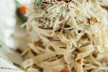 Pasta in cream sauce with caviar on a white dish