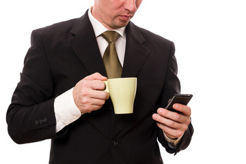 Gesch&auml;ftsmann mit Tasse und Handy