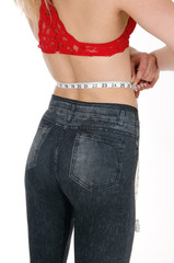 Woman measuring her waist.