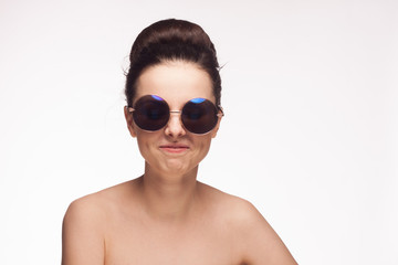 fashionable woman in sunglasses, light background
