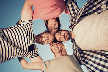 Group of happy young people in circle outdoors