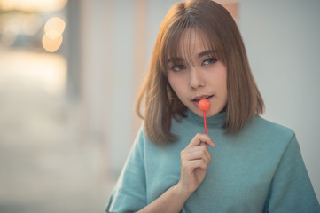 Portrait Happy with brown hair woman eating candy