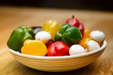 fresh vegetables and pasta lying on a wooden table.