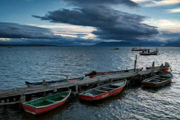 Naklejka na ściany i meble Boats at the pier and ships at sea. Puerto Natales. Chile.