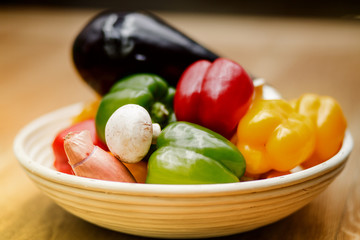 fresh vegetables and pasta lying on a wooden table.