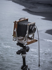 Large format camera with wire shutter on a tripod in a beach in winter
