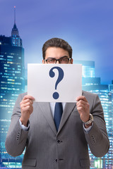 Businessman in uncertainty concept with question marks