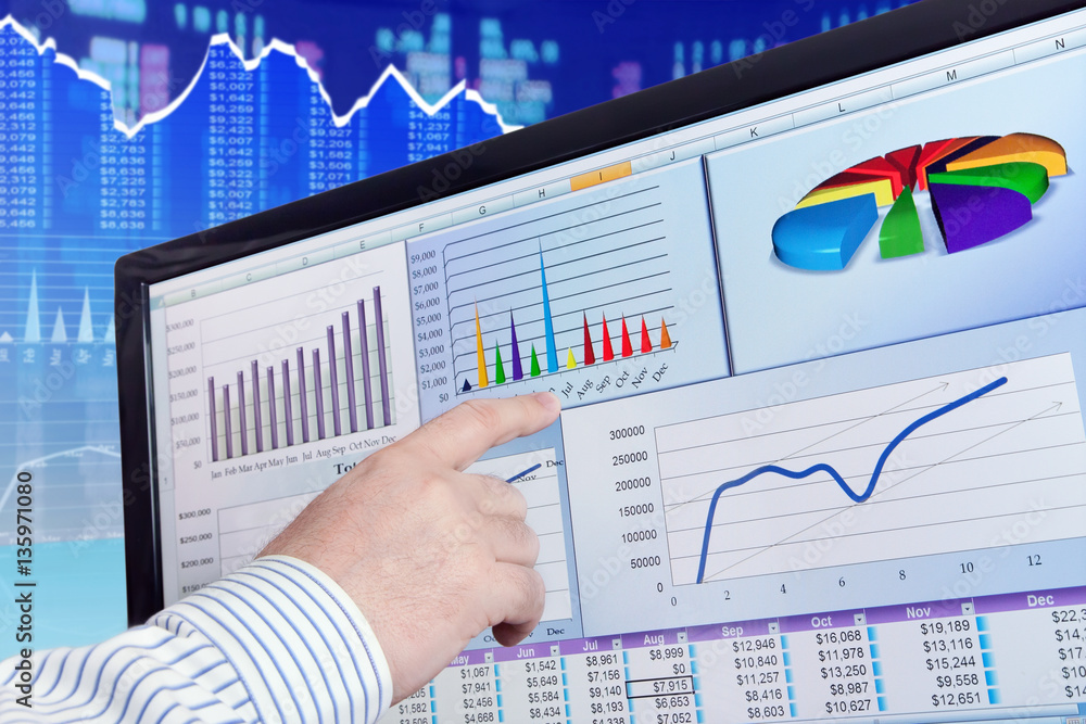 Fototapete man analyzing financial data and charts on computer screen