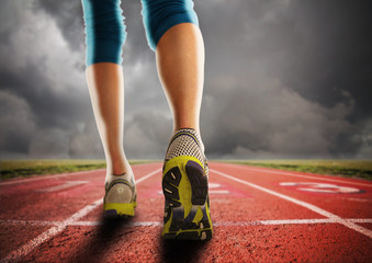 an athletic pair of legs going for a jog or run during sunrise o