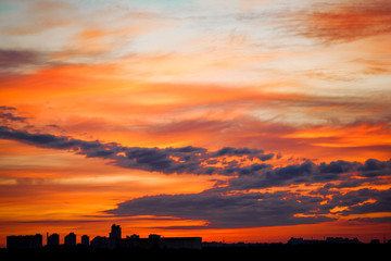 Naklejka premium Sunrise in city landscape. Urban sunset. Rays of the sun above t