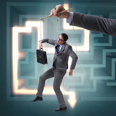 Businessman puppet being manipulated by boss