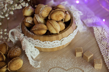 Fototapeta na wymiar Homemade nuts cookies on old wooden table. Holiday decoration ho