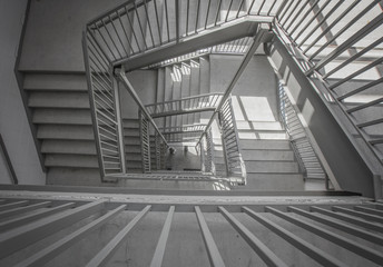 a moody stairwell taken from the top view and done in black and