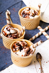 Delicious ice cream in a cup with chocolate sauce cream rolls