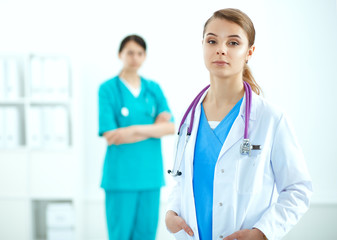 Fototapeta premium Attractive female doctor in front of medical group