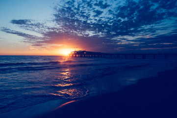Fototapeta premium Sunset over the pier of Lido di Camaiore, Italy