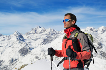 Fototapeta na wymiar Man mountain winter clothes. Ski touring in italian Alps, Gran Paradiso National Park