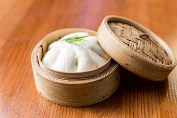 Asian steam bun bao in a bamboo steamer