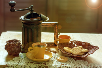 Colazione con il caffè macinato con una macinacaffè antica e biscotti