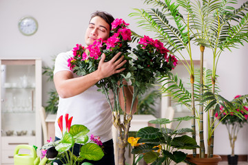Man taking care of plants at home