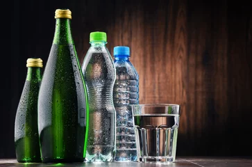 Fototapeten Composition with glass and bottles of mineral water © monticellllo