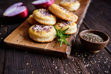 Salty pies with red onion and cumin