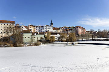 Snowy winter royal medieval Town Pisek above the frozen river Otava, Czech Republic 