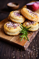 Salty pies with red onion and cumin