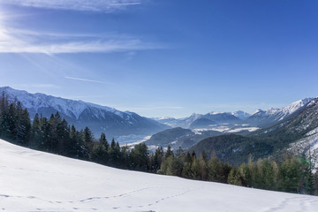 Fototapeta na wymiar Winter mountains landscape track and blue sky in sunny day. Tirol, Austria