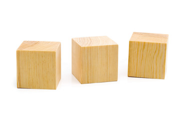 Three brown wooden cubes lined up