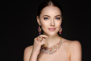 Beautiful woman in a necklace, earrings and ring. Model in jewel - obrazy, fototapety, plakaty