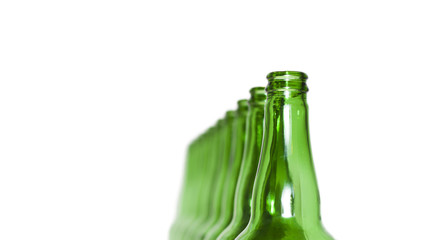 Row of open empty green bottles isolated on white background
