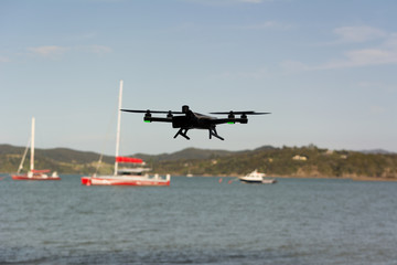 Fototapeta na wymiar Drone flying with sailing boat in background