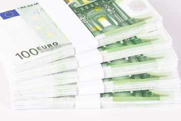 Close-up of Stacks of 100 Euro Banknotes isolated on white background