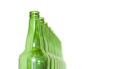 Row of open empty green bottles isolated on white background