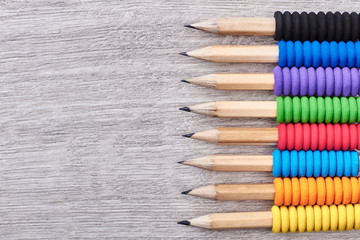 Pencils on wooden surface. Row of colourful pencils. Drawing develops imagination.