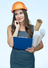 Thinking woman architect holding blueprints and clipboard.