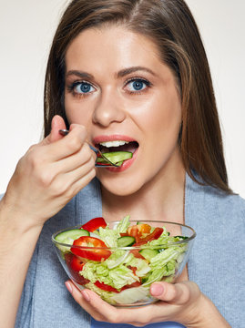 Woman eating salad. Close up face portrait.