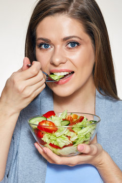Woman eating salad. Close up face portrait.