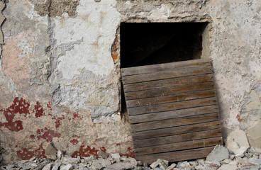 Damaged Tunnel Entrance and Concrete Wall with Wooden Door and Concrete Rubble